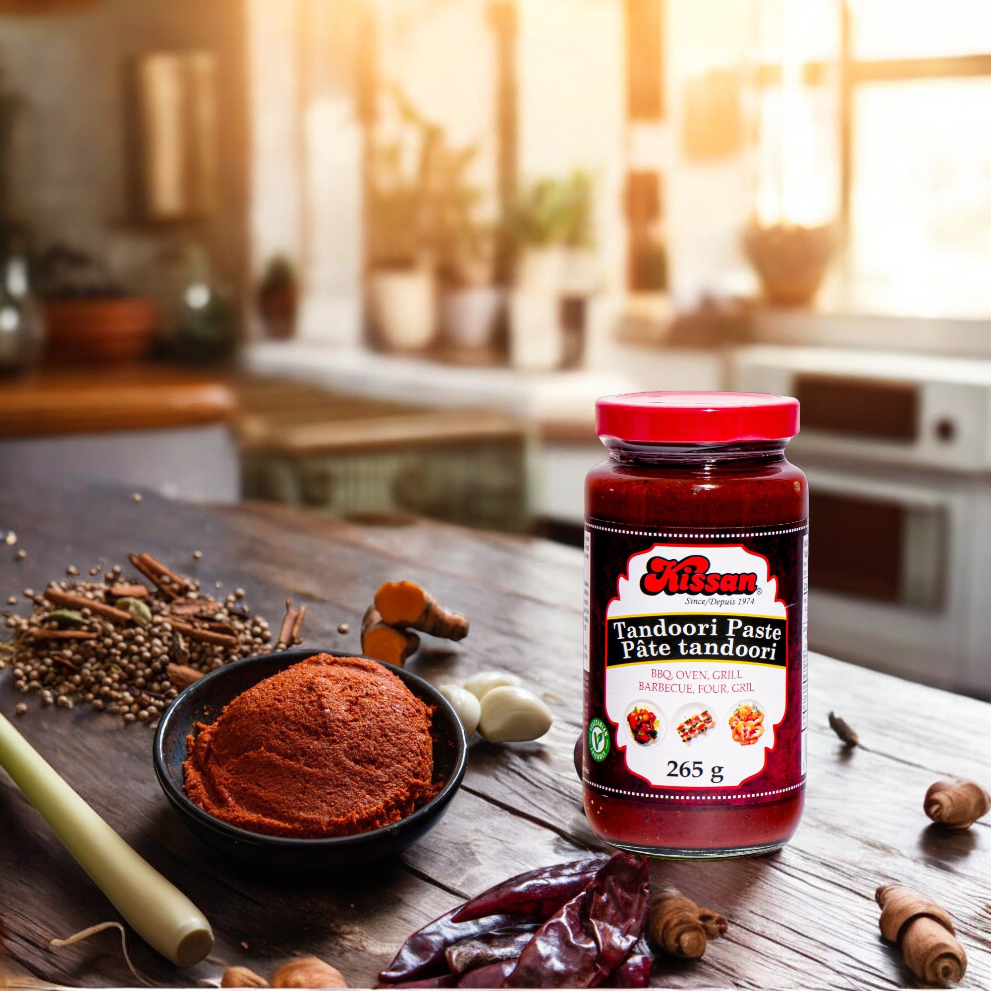 Bottle of Kissan Tandoori Paste 265g with spices around and a bowl with the paste on it.